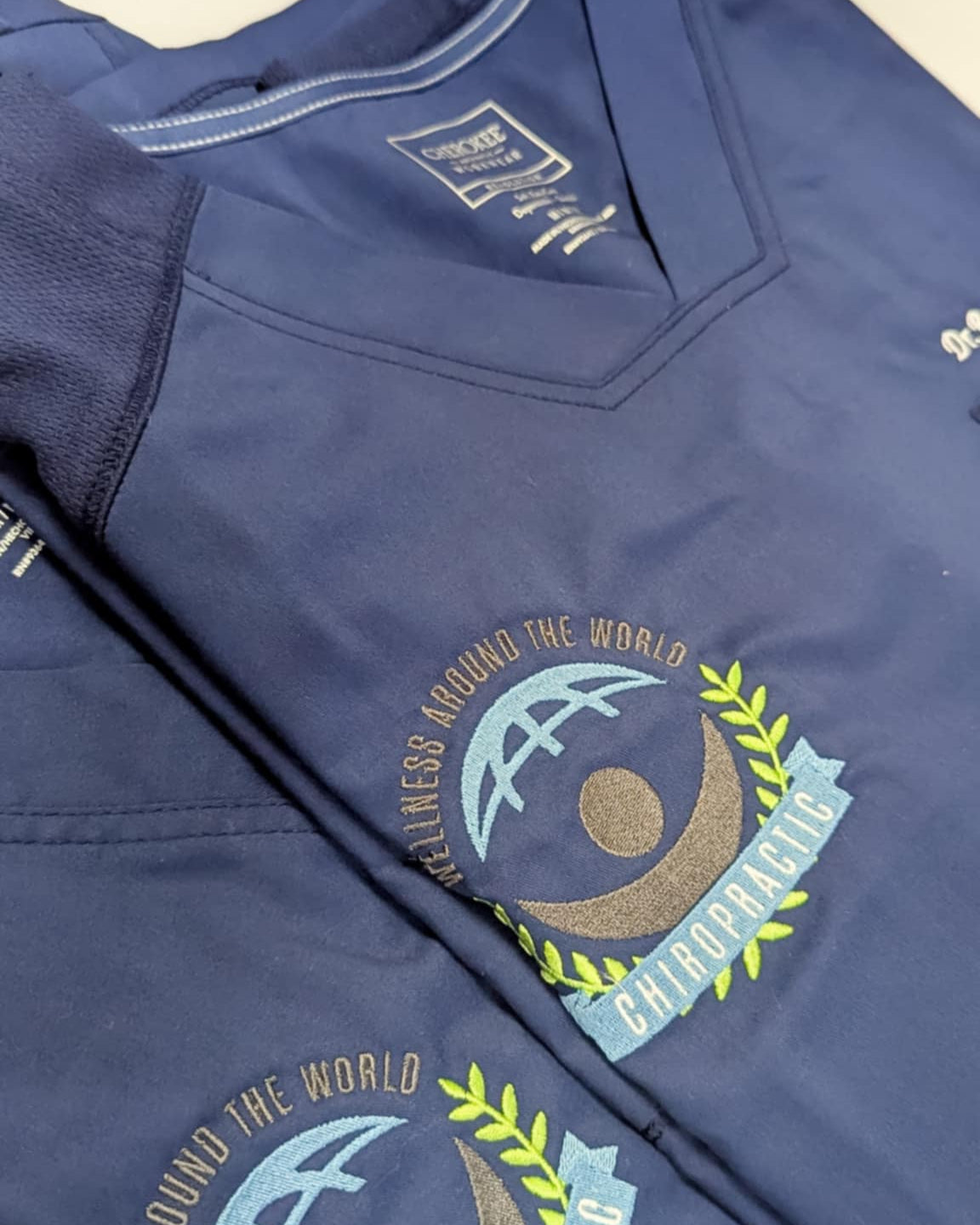 Navy blue shirt with embroidered design on a white background