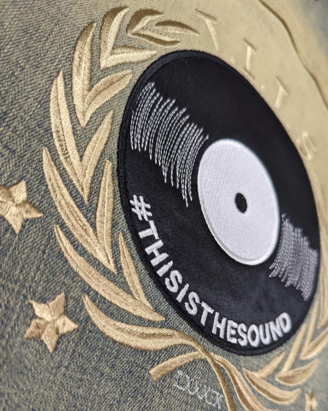 Embroidered patch with 'THISISTHESOUND' text on a textured fabric background